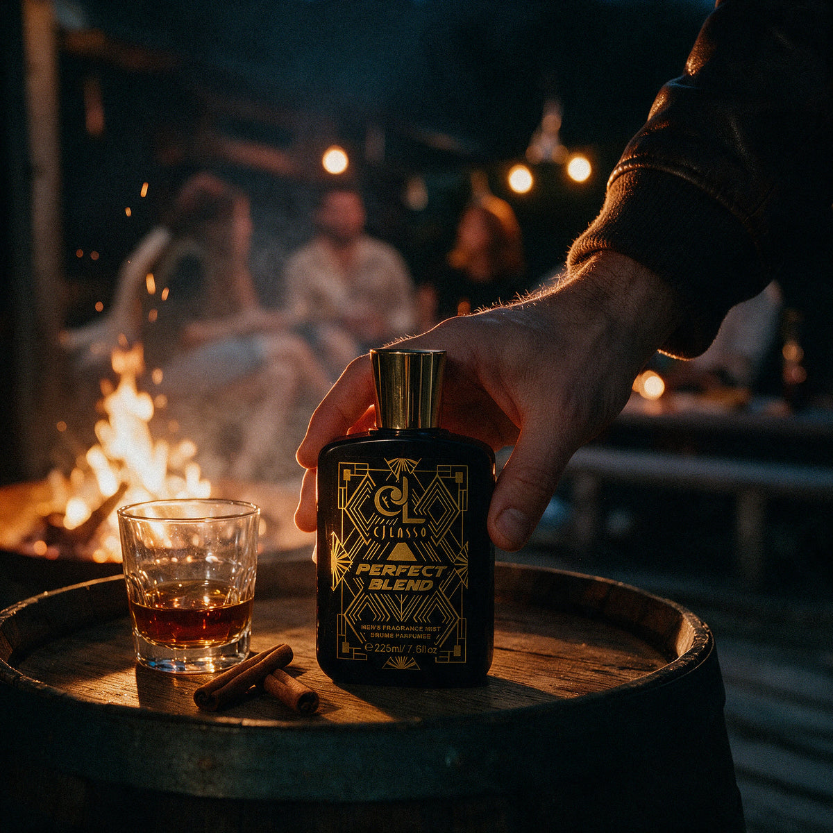 Hand holding the Perfect Blend fragrance mist by a campfire